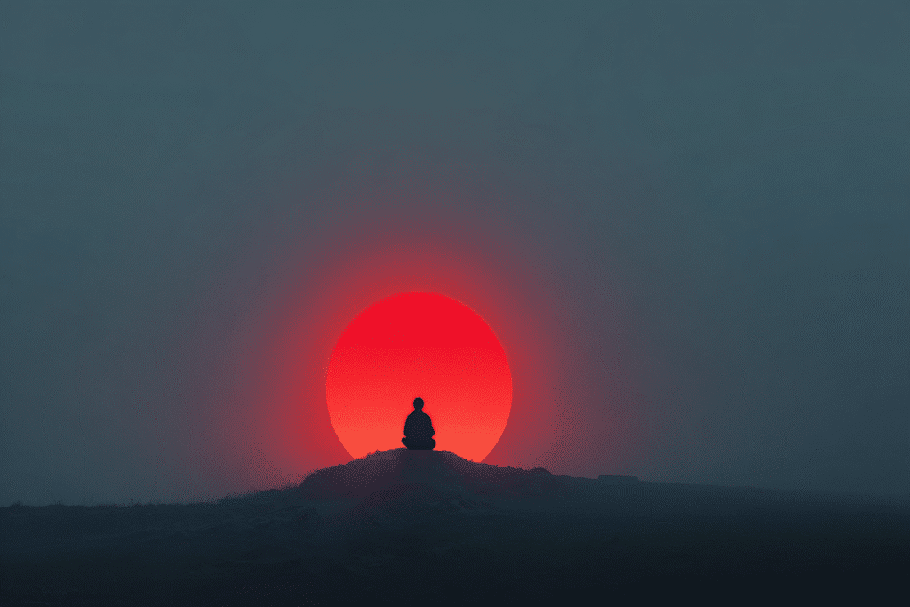 meditating on a hill beneath a red moon